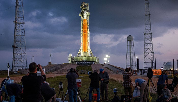 People set cameras to photograph Nasas Artemis II lunar flyby mission, with the next-generation moon rocket, the Space Launch System (SLS) rocket and the Orion crew capsule, on Pad 39B, ahead of the launch of the Artemis II mission at the Kennedy Space Center in Cape Canaveral, Florida, US, March 31, 2026. — Reuters