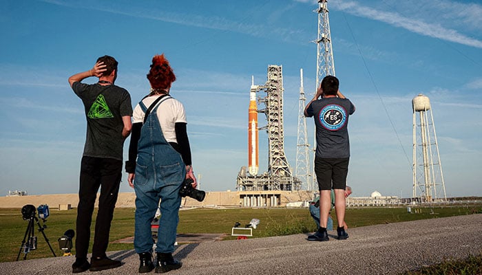 People set cameras to photograph Nasas Artemis II lunar flyby mission, with the next-generation moon rocket, the Space Launch System (SLS) rocket and the Orion crew capsule, on Pad 39B, ahead of the launch of the Artemis II mission at the Kennedy Space Center in Cape Canaveral, Florida, US, March 31, 2026. — Reuters