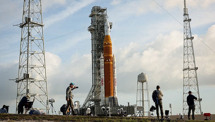 People set cameras to photograph Nasas Artemis II lunar flyby mission, with the next-generation moon rocket, the Space Launch System (SLS) rocket and the Orion crew capsule, on Pad 39B, ahead of the launch of the Artemis II mission at the Kennedy Space Center in Cape Canaveral, Florida, US, March 31, 2026. — Reuters