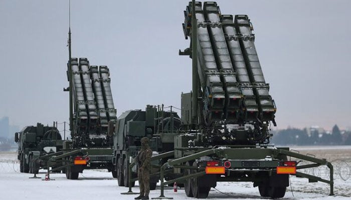 Serviceman patrols in front of the Patriot air defence system during Polish military training on the missile systems at the airport in Warsaw, Poland, February 7, 2023.— Reuters