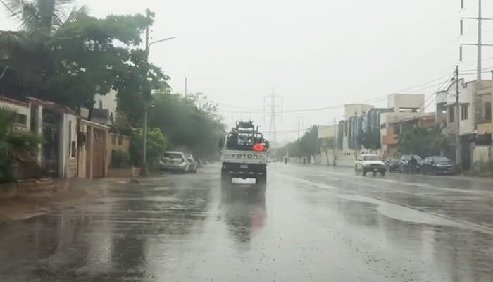 A truck navigates a rain-slicked street in Karachi following heavy showers across the city on 2 April 2026. — Geo News