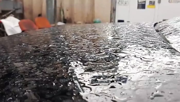 Beaded water droplets rest on a car bonnet in Karachi following heavy showers across the city, 2 April 2026. — Geo News