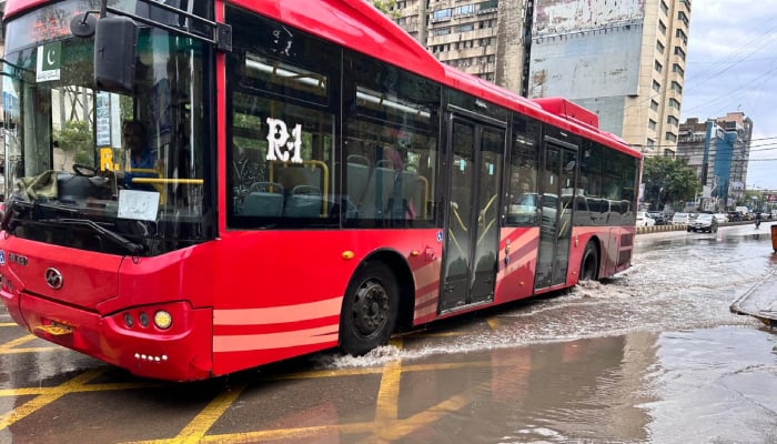 A Peoples Bus Service vehicle wades through a waterlogged road after heavy rainfall in Karachi on April 2, 2026. — Geo.tv