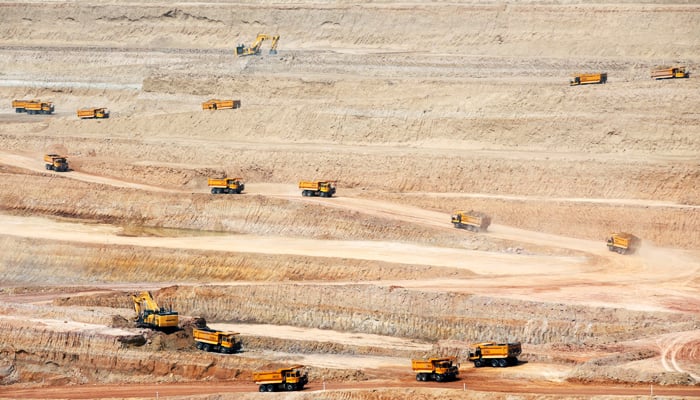 Dump trucks drive at the open-pit coal mining site in Islamkot, Tharparkar, on, September 21, 2017. — Reuters