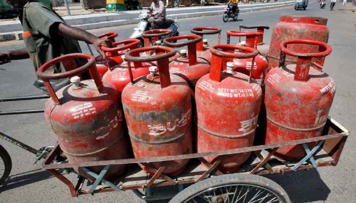 A man pushes a trishaw loaded with cooking gas cylinders in the western Indian city of Ahmedabad April 29, 2010. — Reuters