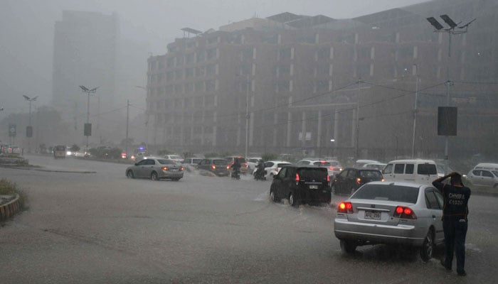 Motorists drive during heavy rainfall in Karachi on April 2, 2026. — ONLINE