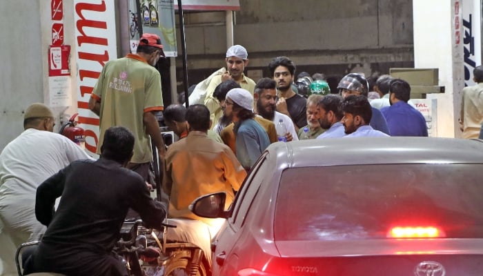People gathered at a petrol pump station for purchase petrol in Karachi, March 6, 2026. — Online