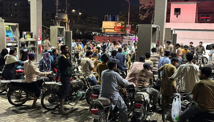 People on their vehicles wait for their turn to get fuel at a petrol station, as fuel prices in Pakistan rise, amid the US-Israeli conflict with Iran, in Karachi, Pakistan, April 2, 2026. — Reuters