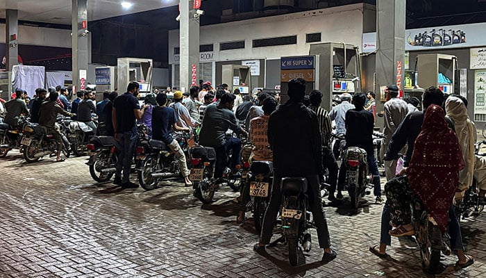 People on their vehicles wait for their turn to get fuel at a petrol station, as fuel prices in Pakistan rise, amid the US-Israeli conflict with Iran, in Karachi, Pakistan, April 2, 2026. — Reuters
