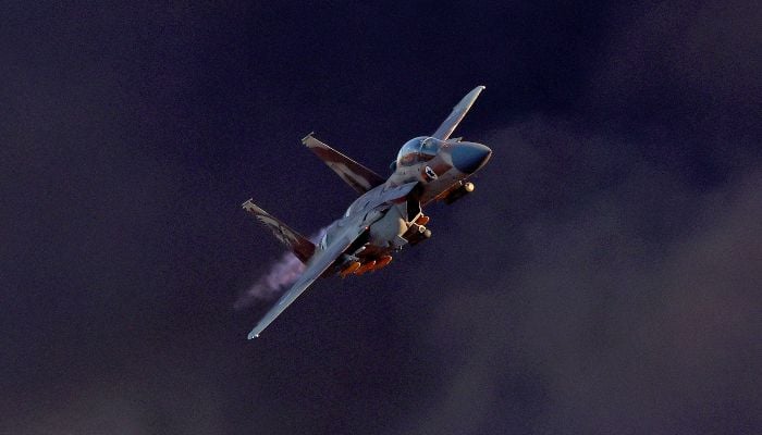 Israels F-15E Strike Eagle fighter plane performs manoeuvres during the graduation ceremony of Israeli Air Force pilots at the Hatzerim base in the Negev desert, near the southern city of Beer Sheva, on June 29, 2023. — AFP