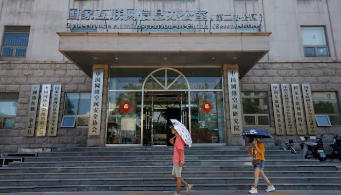 People walk past an office of the Cyberspace Administration of China (CAC) in Beijing, China July 8, 2021. — Reuters