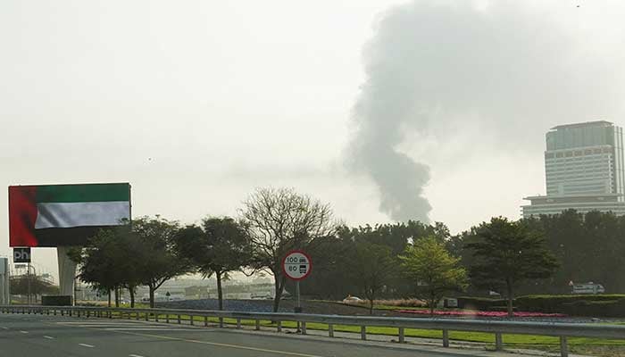 Smoke rising from an area near the Dubai International Airport is seen through the windshield of a vehicle, after a drone attack hit a fuel tank, according to Dubai authorities, amid the US-Israel conflict with Iran, in Dubai, United Arab Emirates, March 16, 2026. — Reuters