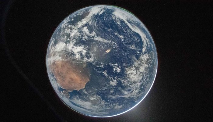 This handout picture provided by Nasa shows Earth as seen through the Orion spacecrafts window, photographed by NASA astronaut Reid Wiseman, commander of Artemis II, on April 2, 2026. — AFP