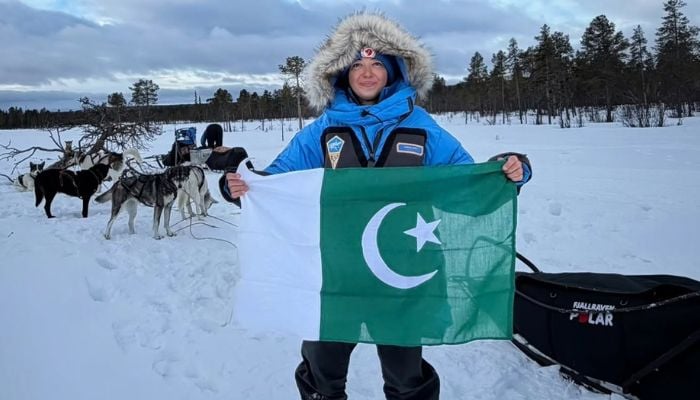 Pakistani adventure athlete and snowboarder Samar Khan raises the Pakistani flag on the Fjallraven Polar 2026. — Instagram/@skhanathlete