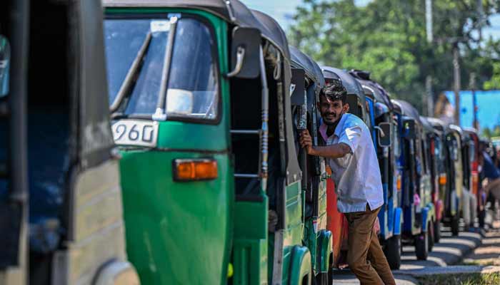 Drivers wait in a queue to refuel their auto rickshaws at a fuel station in Biyagama on the outskirts of Colombo on March 15, 2026.— AFP/File