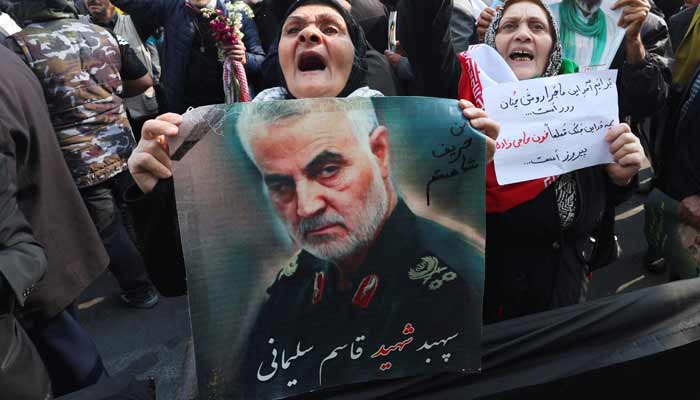 A woman holds a poster of the late senior Iranian military commander General Qassem Soleimani during the funeral of Iranian security chief Ali Larijani and victims of the IRIS Dena warship at Enghelab Square, amid the US-Israeli conflict with Iran, in Tehran, Iran, March 18, 2026.— Reuters/File