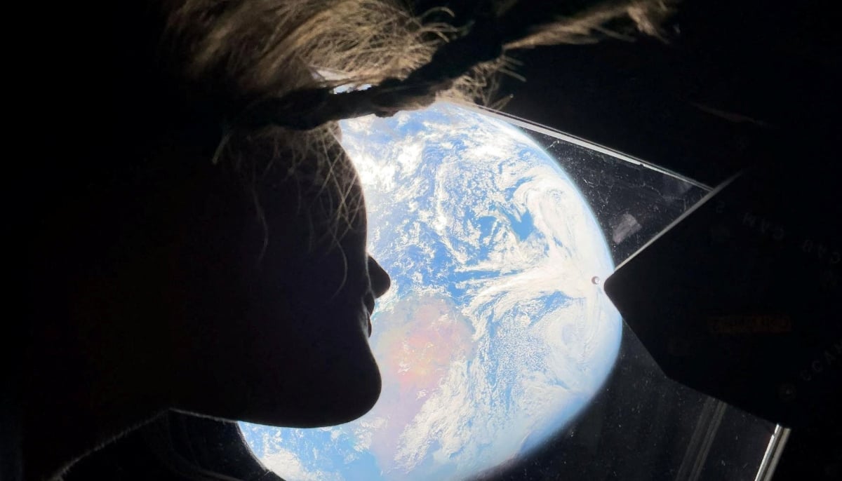Nasa astronaut and Artemis II mission specialist Christina Koch peers out of one of the Orion spacecrafts main cabin windows, looking back at Earth, as the crew travels towards the moon April 2, 2024. — Reuters