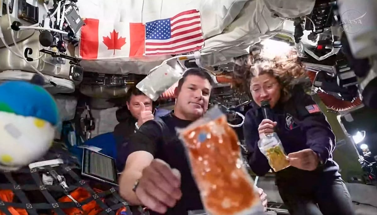 This screengrab taken from a Nasa livestream shows Artemis II mission astronauts (left to right Nasa´s commander Reid Wiseman, Canadian Space Agency´s mission specialist Jeremy Hansen and Nasa´s mission specialist Christina Koch during a brief demonstration of the food they eat in space to respond a question during a VIP call with Canadian children inside the Orion spacecraft while on their way to the moon on April 4, 2026. — AFP