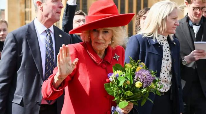 Queen Camilla receives bouquet before brightening Easter in red-hot