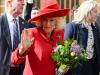 Queen Camilla receives bouquet before brightening Easter in red-hot