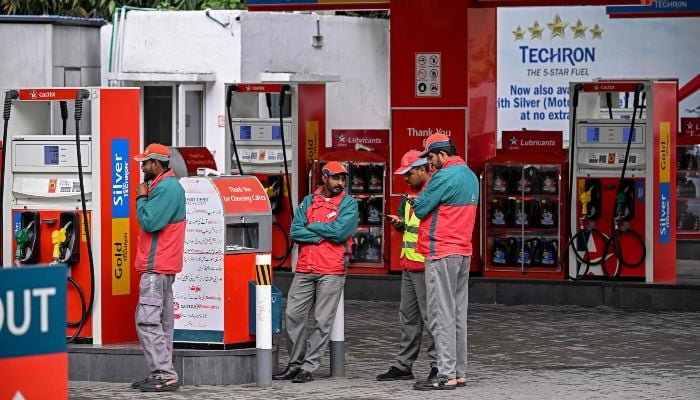 Workers wait for customers at a fuel station after the government raised fuel prices in Islamabad on April 3, 2026. — AFP