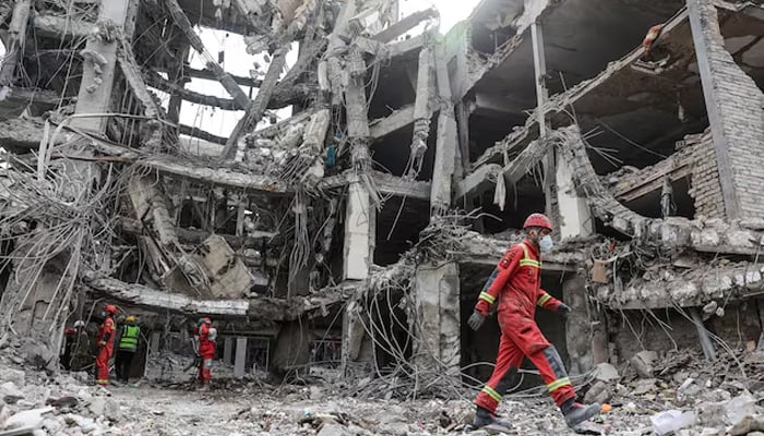Emergency personnel work at the site of a strike, amid the US-Israeli conflict with Iran, in Tehran, Iran, March 12, 2026. — Reuters