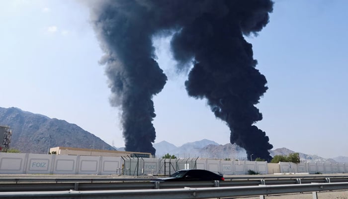 Smoke rises in the Fujairah oil industry zone, caused by debris after interception of a drone by air defences in Fujairah, United Arab Emirates, March 14, 2026. — Reuters