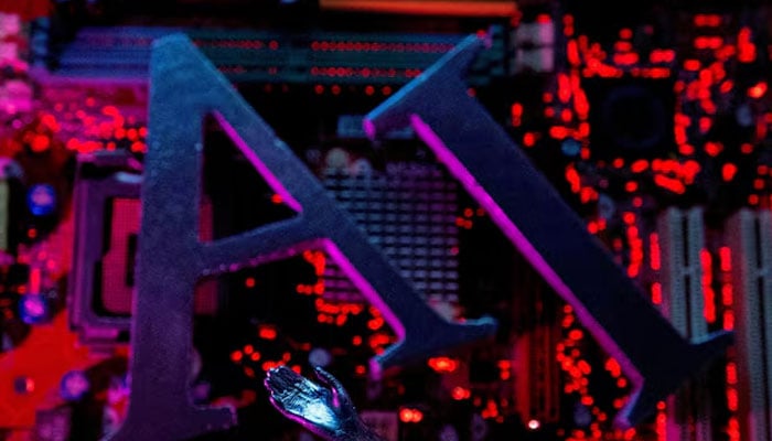 AI (Artificial Intelligence) letters and robot hand are placed on computer motherboard in this illustration created on June 23, 2023. — Reuters