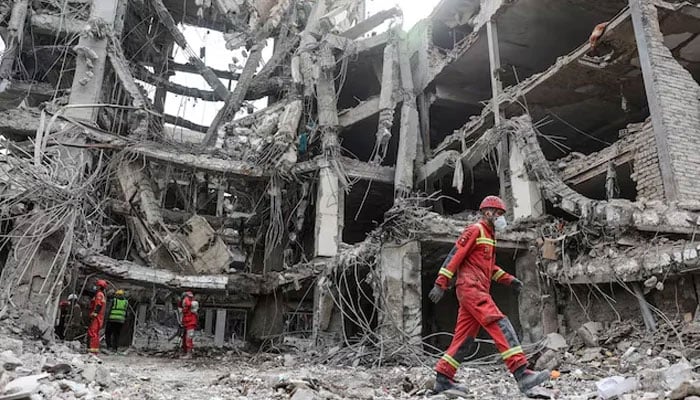 Emergency personnel work at the site of a strike, amid the US-Israeli conflict with Iran, in Tehran, Iran, March 12, 2026. — Reuters