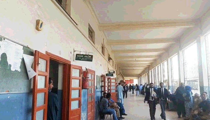 People walk through a hallway at a lower court in Karachi in this undated image. — Geo News