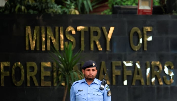 A police officer stands guard outside the Ministry of Foreign Affairs office in Islamabad, March 25, 2026. — Reuters