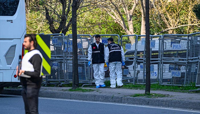 Police forensic officers inspect a scene near the Israeli consulate in Istanbul on April 7, 2026, following a shootout between gunmen and police. — AFP