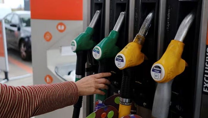 A person uses a petrol pump, as the price of petrol rises, in Lisbon, Portugal, March 7, 2022. Picture taken March 7, 2022. — Reuters