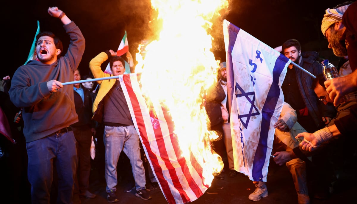 People burn the flags of the US and Israel, as they gather after a two-week ceasefire in the Iran war was announced, in Tehran, Iran, April 8, 2026. — Reuter