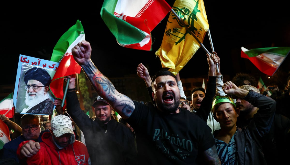 People shout slogans as they gather after a two-week ceasefire in the Iran war was announced, in Tehran, Iran, April 8, 2026. — Reuters