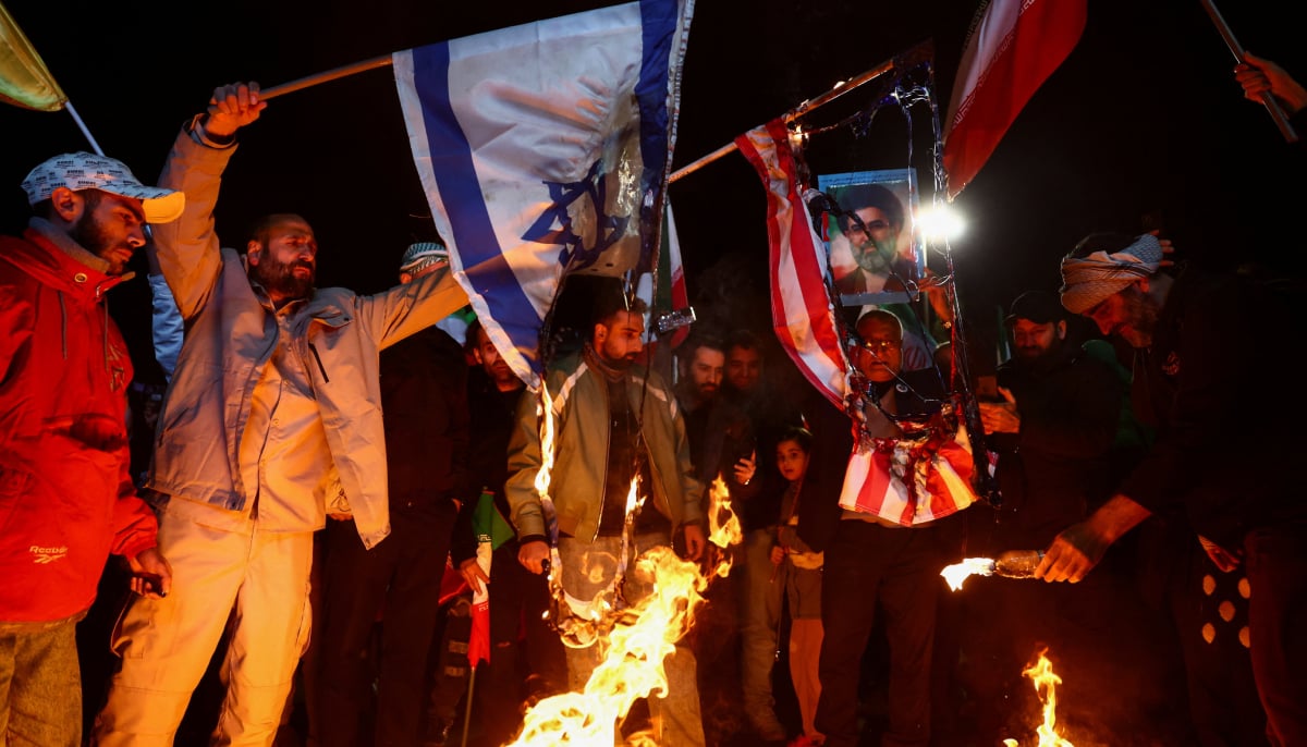 People burn the flags of the US and Israel, as they gather after a two-week ceasefire in the Iran war was announced, in Tehran, Iran, April 8, 2026. — Reuters