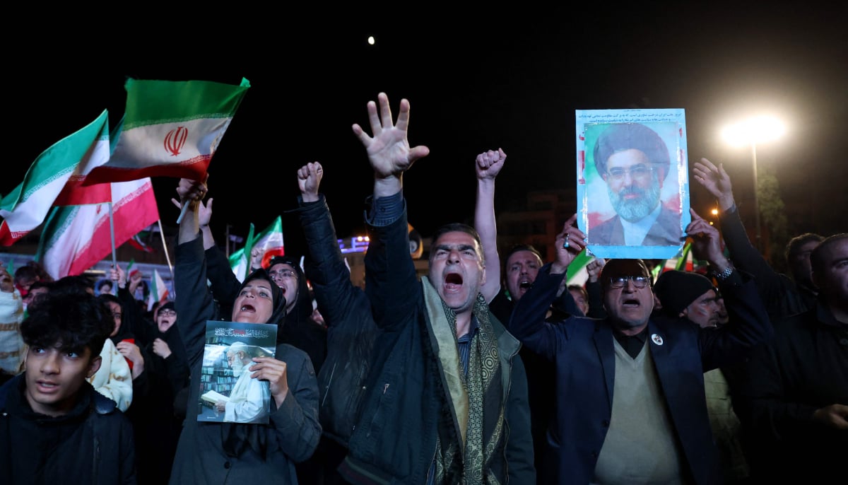 People shout slogans after a ceasefire announcement at the Enqelab square, in Tehran, on April 8 2026. — AFP