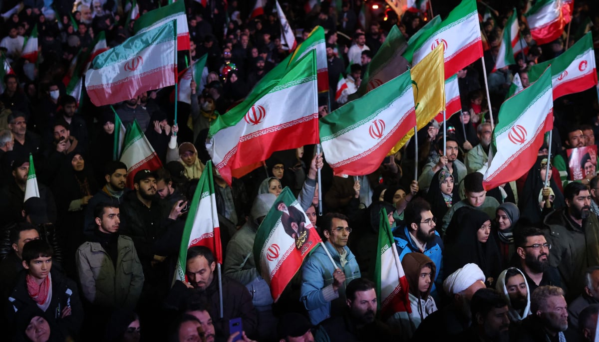 Iranians react after a ceasefire announcement at the Enqelab square, in Tehran, on April 8 2026. — AFP