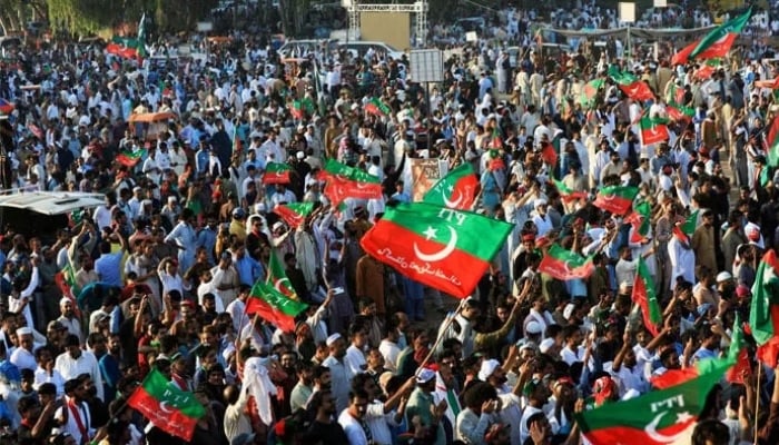 PTI workers wave party flags during a rally in Islamabad. — Reuters/File