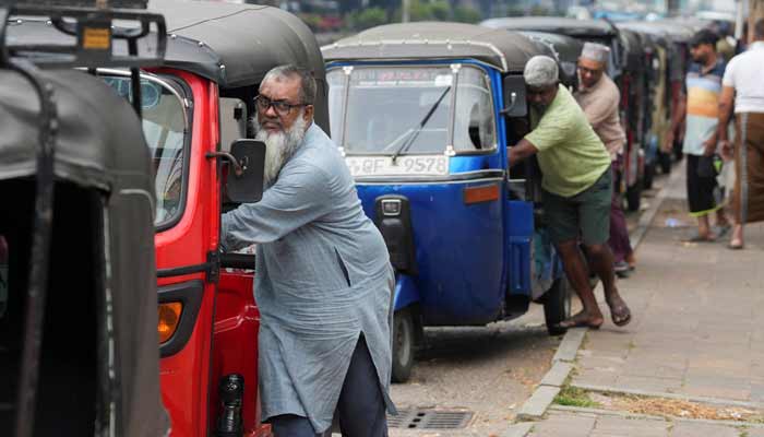 Drivers push their autorickshaws as they wait in a queue to refuel outside a fuel station, after the government declared a weekly Wednesday holiday for public officials to conserve fuel amid concerns over fuel supplies during the US-Israel conflict with Iran, in Colombo, Sri Lanka, March 18, 2026.— Reuters/File