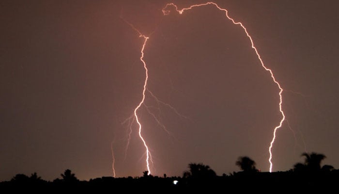 This representational file photo shows a lightning strike near the residents balling during a thunderstorm. — Reuters