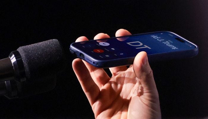 US Vice President JD Vance holds a mobile phone while on a call with US President Donald Trump to a microphone during a Day of Friendship event with Hungarian Prime Minister Viktor Orban (not in picture) at MTK Sportpark in Budapest, Hungary on April 7, 2026. — AFP