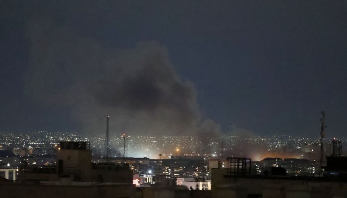 A plume of smoke rises from the site of a strike in Tehran early on March 28, 2026. — AFP