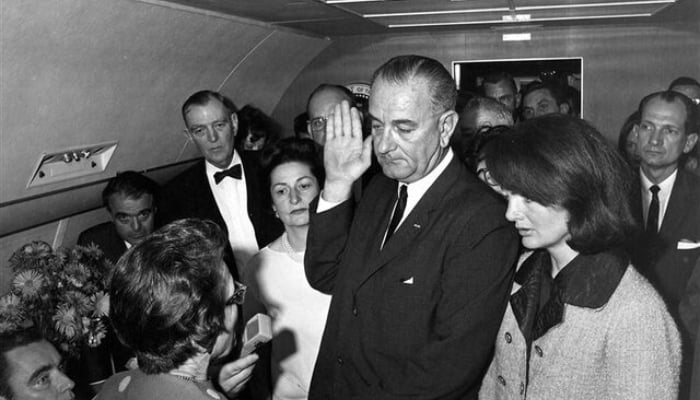Lyndon Baines Johnson (centre) taking oath as US President aboard Air Force One at Love Field in Dallas Texas, US in this handout image taken on November 22, 1963. — Reuters