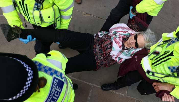 Police officers detain a protester at Everyone Day, a mass vigil and sign-holding event in Trafalgar Square organised by Defend Our Juries to demand the lifting of the ban on Palestine Action, in London, Britain, April 11, 2026.— Reuters