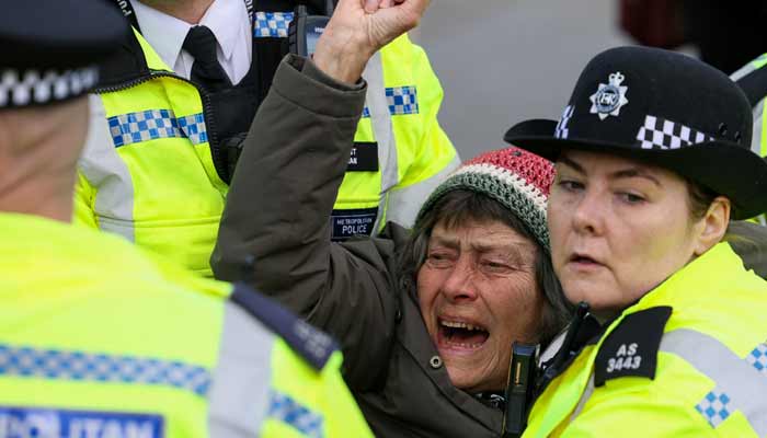 Police officers detain a protester at Everyone Day, a mass vigil and sign-holding event in Trafalgar Square organised by Defend Our Juries to demand the lifting of the ban on Palestine Action, in London, Britain, April 11, 2026.— Reuters