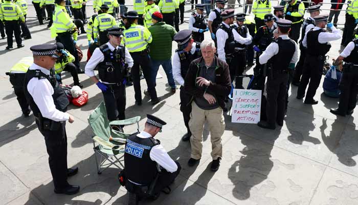 Police officers detain a protester at Everyone Day, a mass vigil and sign-holding event in Trafalgar Square organised by Defend Our Juries to demand the lifting of the ban on Palestine Action, in London, Britain, April 11, 2026.— Reuters