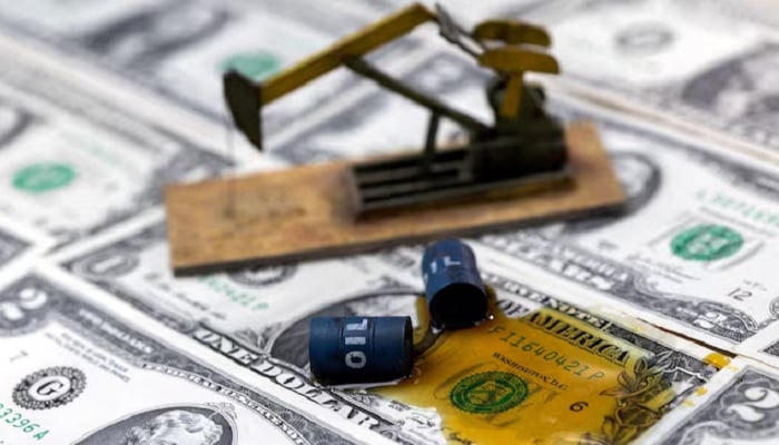 Oil, miniatures of oil barrels, oil pump jack and U.S. dollar banknote are seen in this illustration taken, June 6, 2023. — Reuters