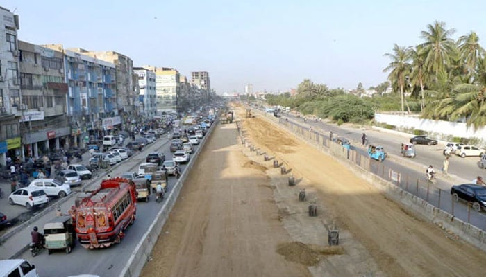 A view of the development work of Red Line is underway with the help of heavy machinery at University Road in the Provincial Capital. — APP/File