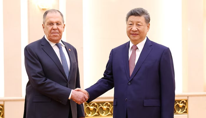 Chinese President Xi Jinping and Russias Foreign Minister Sergei Lavrov shake hands at the Great Hall of the People in Beijing, China, April 15, 2026. — Reuters